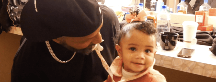 Man with baby in a dressing room.